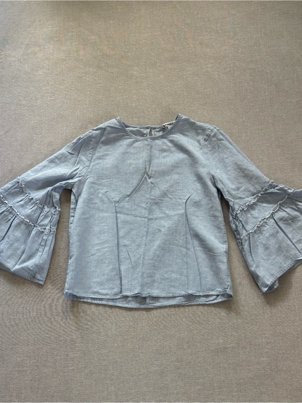 Express blue linen chambray blouse with bell sleeves.